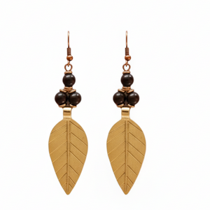Pair of gold leaf-shaped earrings with black beads on a white background