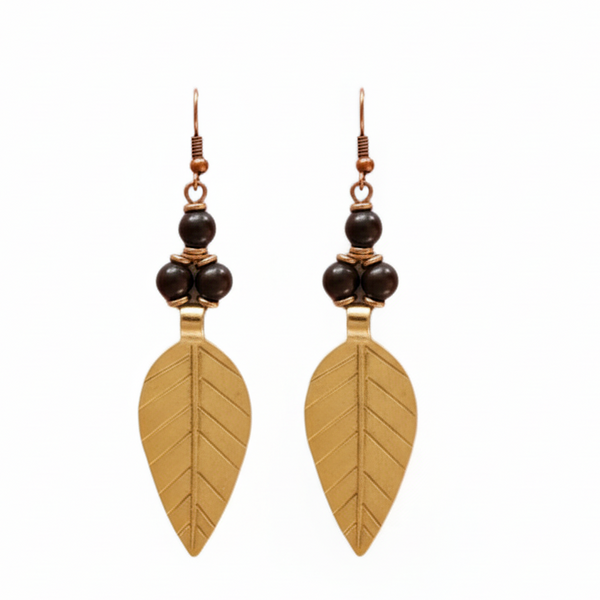 Pair of gold leaf-shaped earrings with black beads on a white background