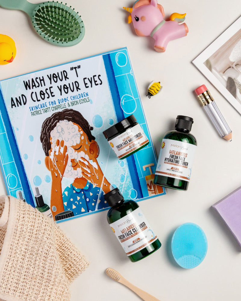 Children skincare products with a book titled 'Wash Your T and Close Your Eyes' on a white surface.