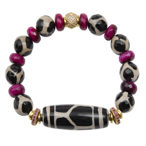 Bracelet with black and white patterned beads and gold accents on a white background