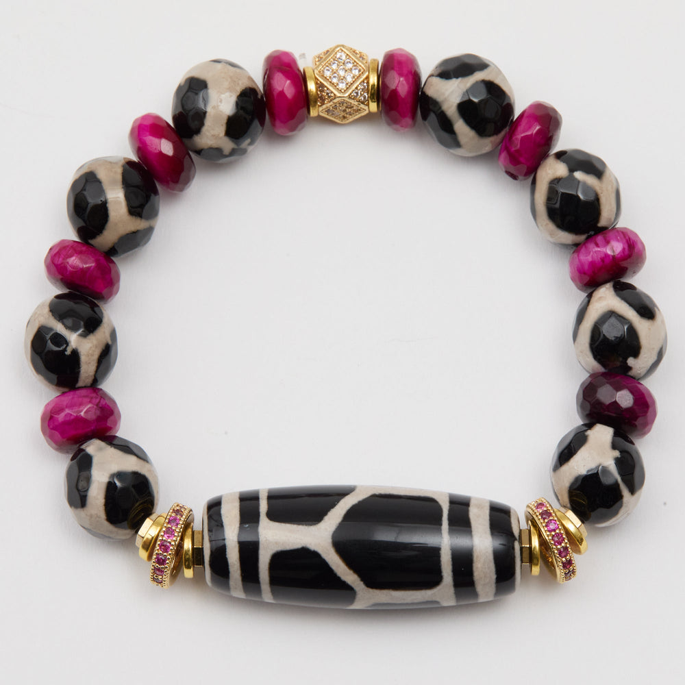 Bracelet with black and white patterned beads and gold accents on a white background
