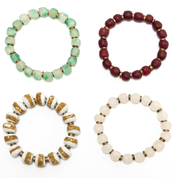 Four beaded bracelets in different colors on a white background