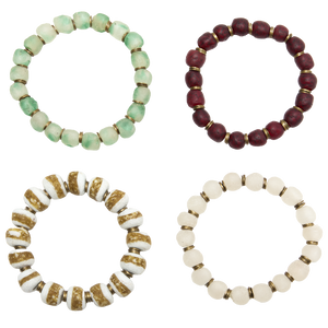 Four beaded bracelets in different colors on a white background