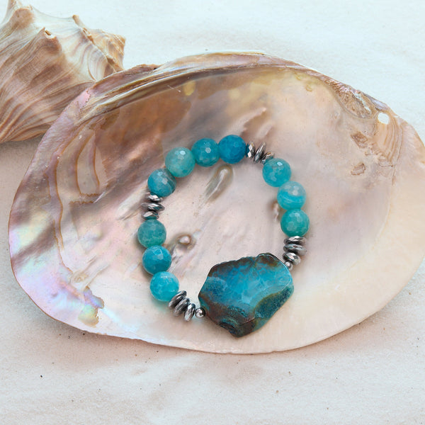 Turquoise beaded bracelet with a large stone on a seashell
