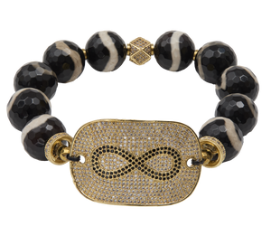 Bracelet with black beads and gold-plated infinity focal  on a white background