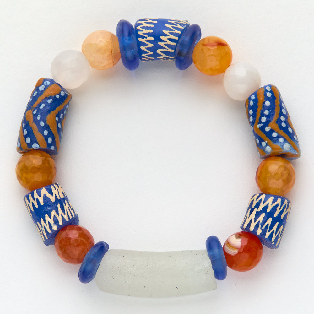 Multicolored beaded bracelet with blue, brown, and white beads on a white background