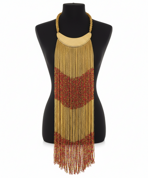 Beaded necklace with gold and red fringes on a mannequin against a white background