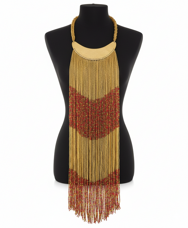 Beaded necklace with gold and red fringes on a mannequin against a white background