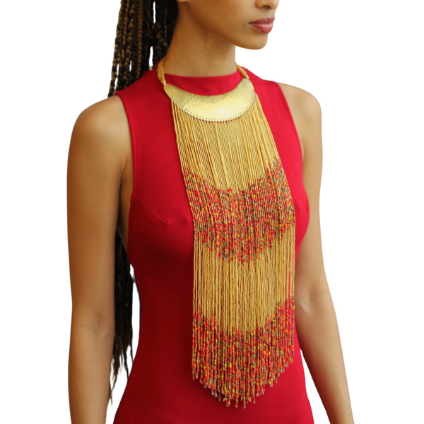 A woman wearing a Maasai long beaded statement necklace with a brass collar, showcasing the necklace's vibrant colors and intricate design.
