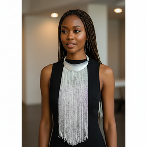 Woman wearing a long, beaded necklace in an indoor setting