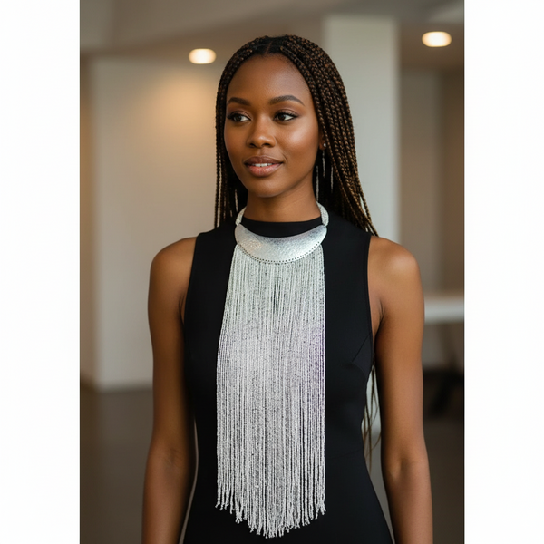 Woman wearing a long, beaded necklace in an indoor setting