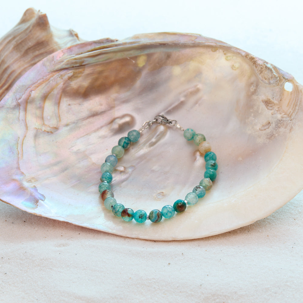 Turquoise beaded bracelet on a large shell