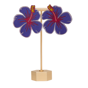 Hand-painted purple hibiscus flower earrings on a gold stand on a white background