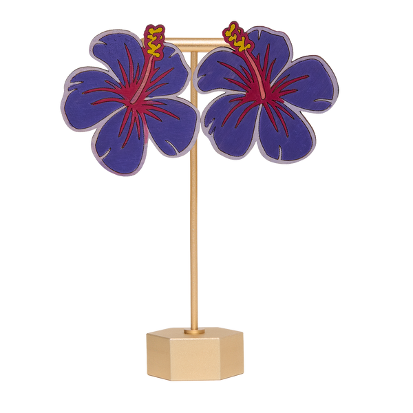 Hand-painted purple hibiscus flower earrings on a gold stand on a white background