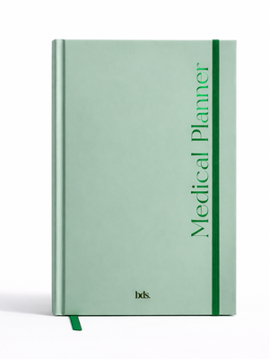 Green hardcover medical planner with vertical text, "Medical Planner," and a matching green elastic band