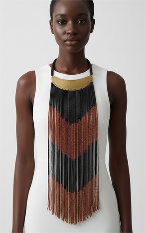 Model wearing a long, beaded necklace with a chevron pattern on a plain background