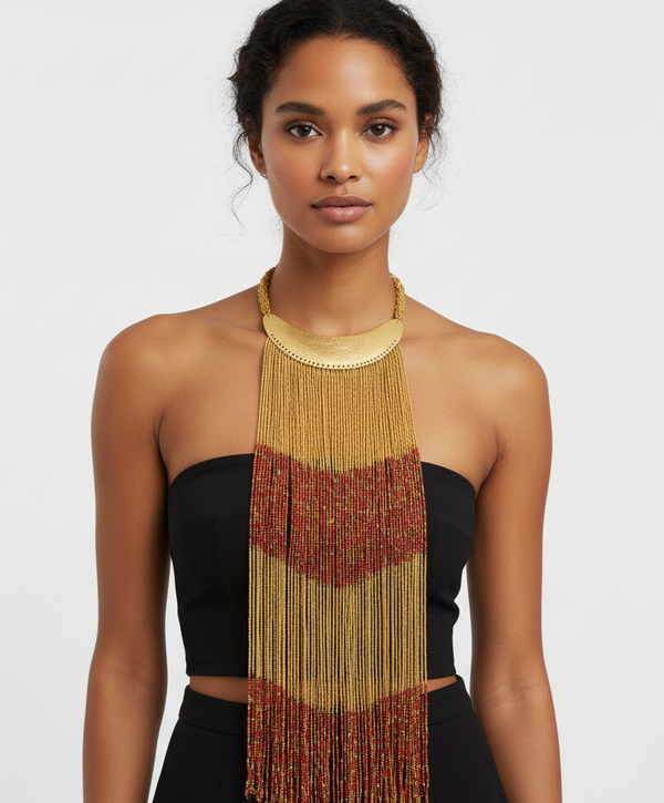 Woman wearing a long, beaded necklace with a plain background