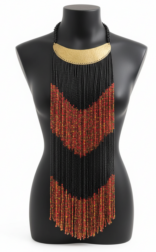 Beaded necklace with black and gold top and red fringe on a mannequin.