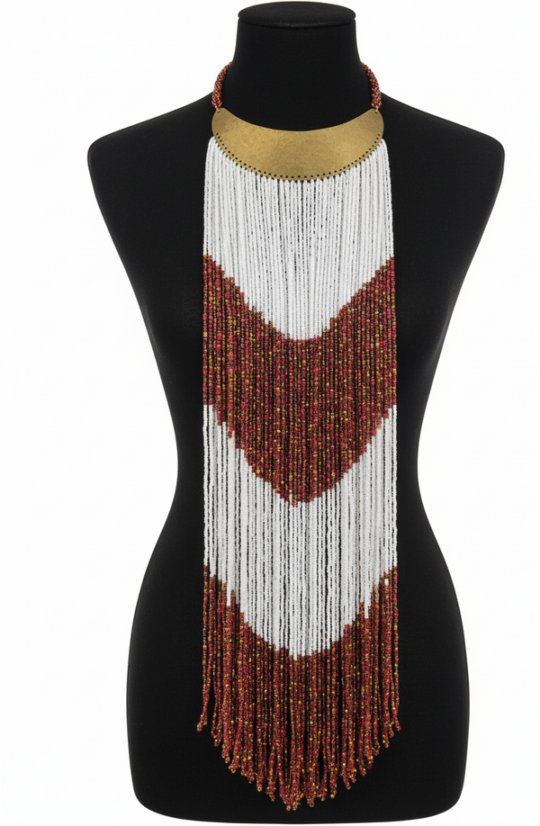 A long beaded necklace with white and red pattern on a black mannequin