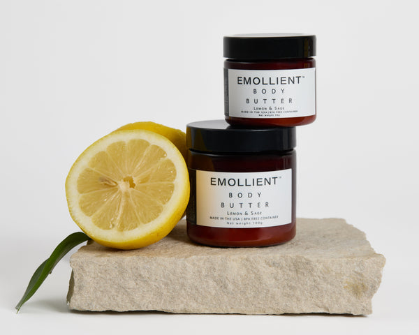 Natural lemon and sage body butter by My Emollient with fresh lemon on stone, non-toxic moisturizer for dry skin