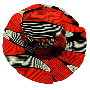 Round fabric swatch with red, black, and white pattern on a white background
