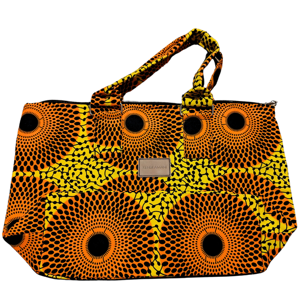 Orange and yellow patterned nairobi totebag with a visible brand label on a white background