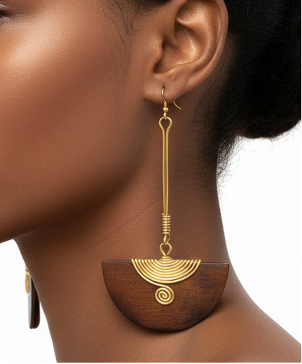 Woman wearing gold earrings on a white background