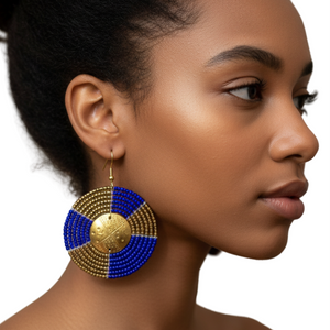 Woman wearing a blue and gold beaded earring on a white background